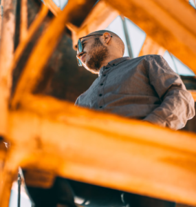 A man standing on a metal structure.