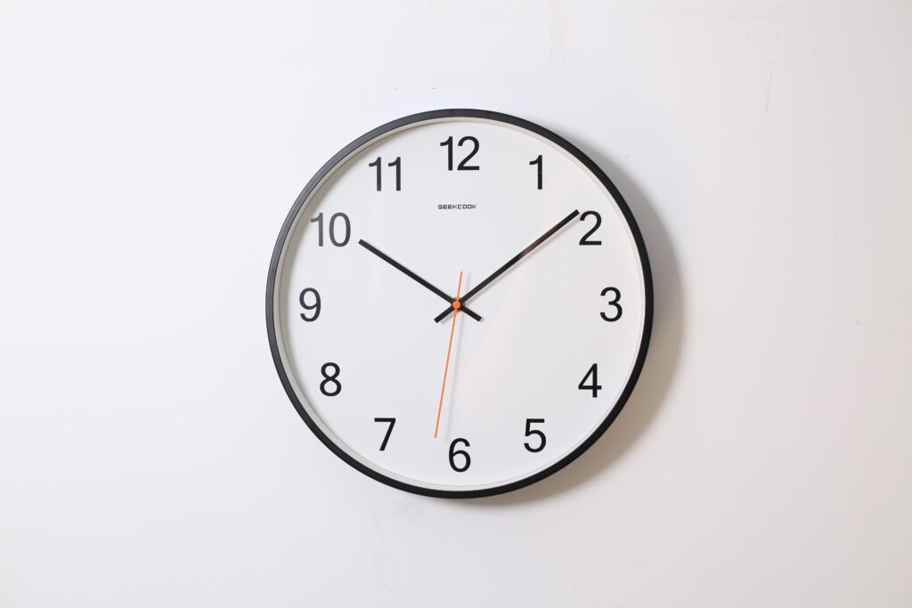 A photo of a clock hanging on the wall.