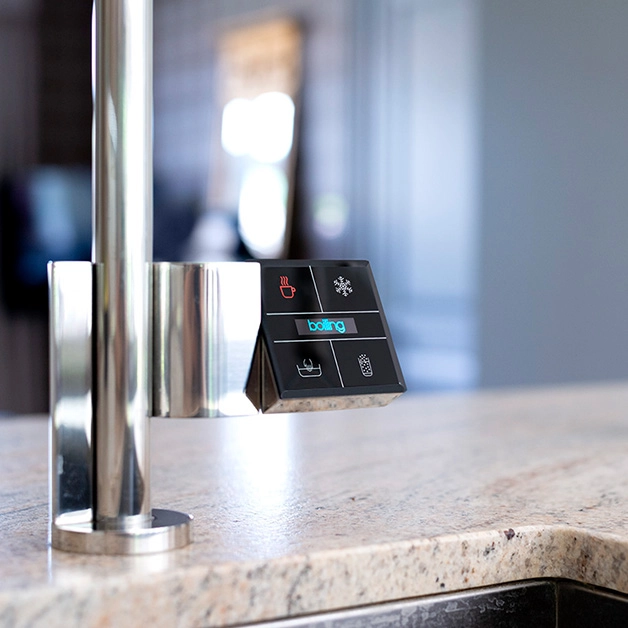 A kitchen faucet with a touch screen on it.