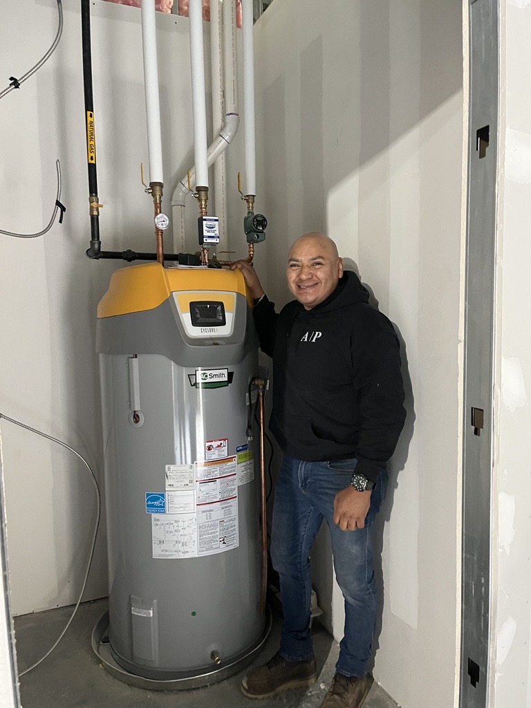 person standing next to a water heater