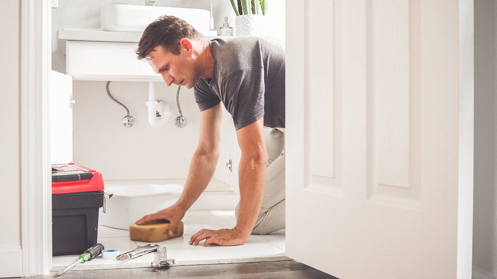 person cleaning the bathroom floor