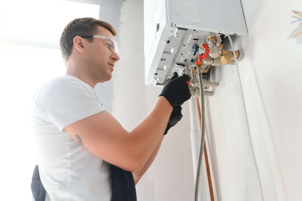 person installing water heater