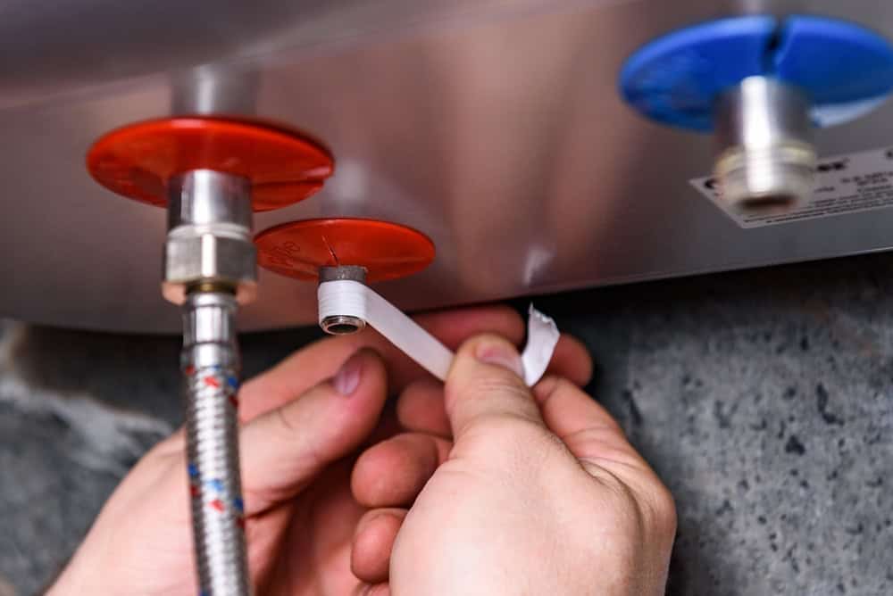 person installing a water heater