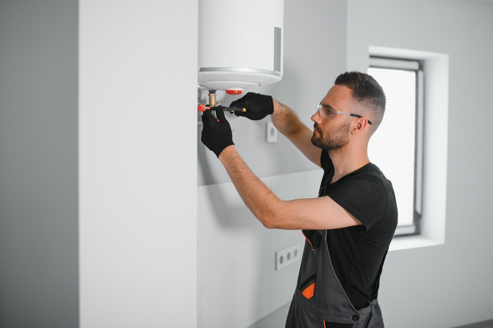 person installing water heater